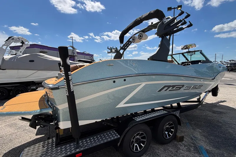 Slide: The Image of 2026 MB B52 23 Alpha boat on trailer under clear blue sky. - 4