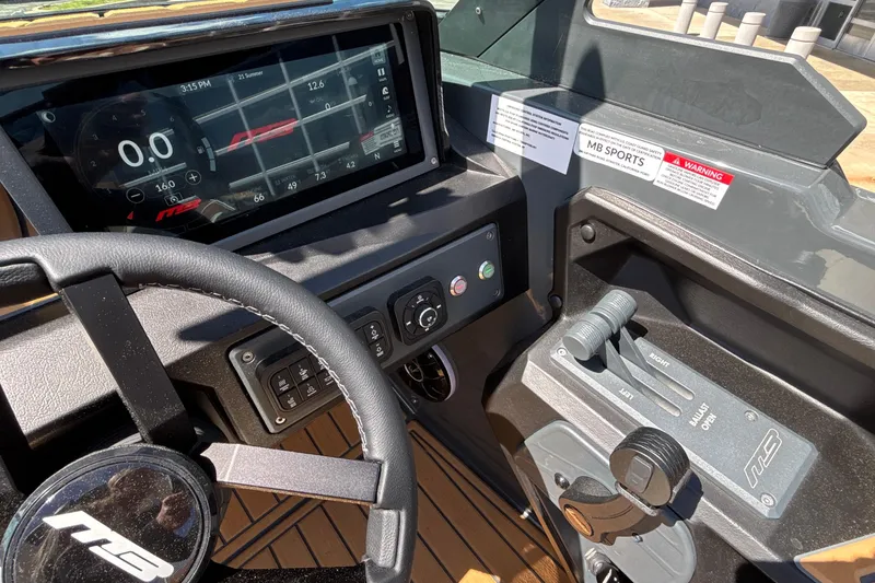 Slide: The Image of 2026 MB B52 23 Alpha boat dashboard with digital display and controls. - 40