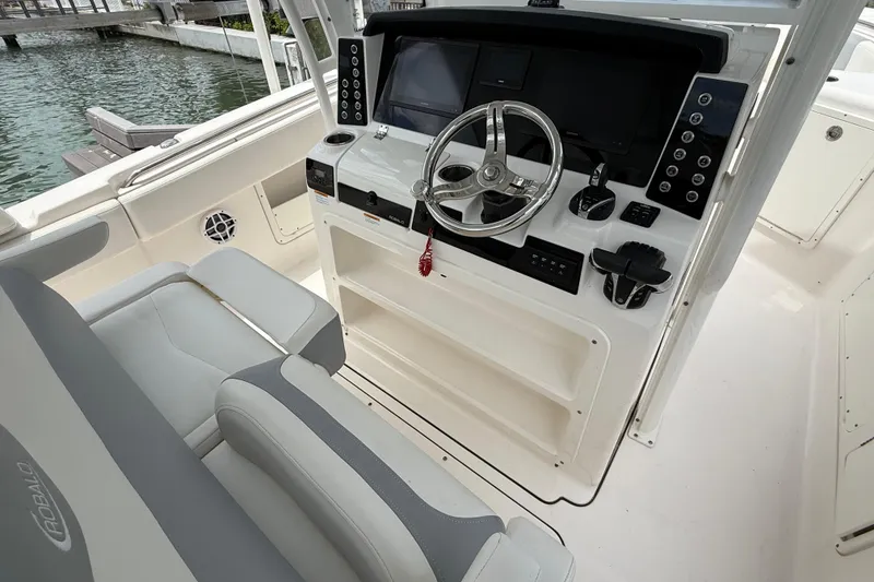 Slide: The Image of 2022 Robalo R302 Center Console boat interior with steering wheel and controls. - 10