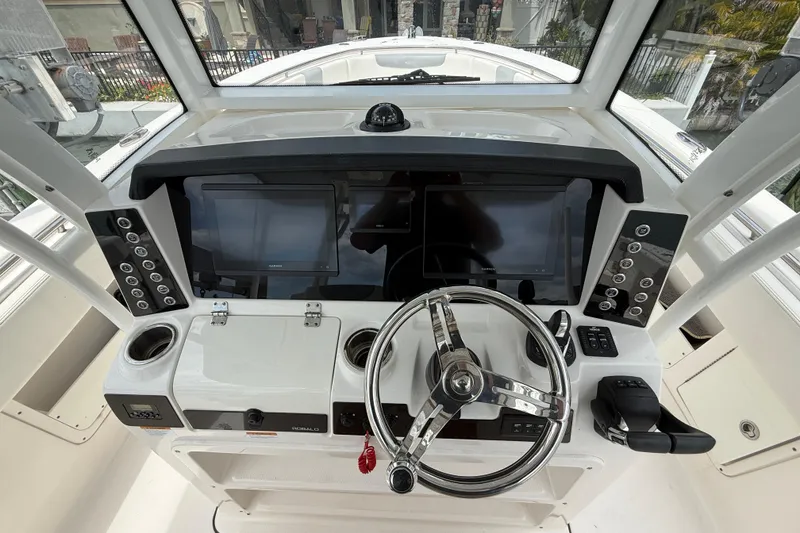 Slide: The Image of 2022 Robalo R302 Center Console helm with dual displays and modern controls. - 11