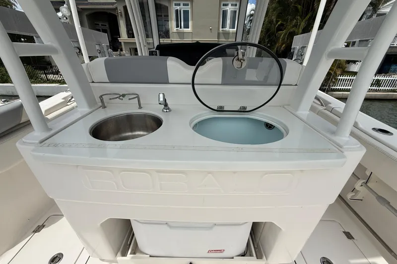 Slide: The Image of 2022 Robalo R302 Center Console boat with sink and storage area. - 14