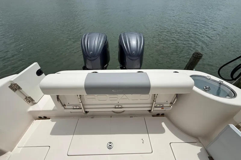 Slide: The Image of 2022 Robalo R302 Center Console boat with dual engines on calm water. - 15