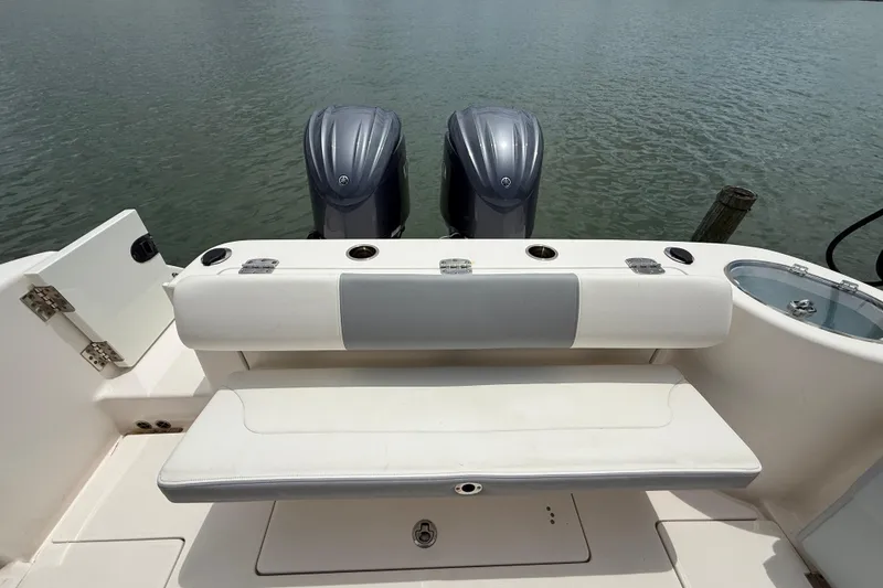 Slide: The Image of 2022 Robalo R302 Center Console boat with dual engines and seating area. - 16