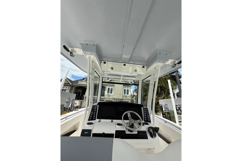 Slide: The Image of 2022 Robalo R302 Center Console boat interior with steering wheel and control panel. - 18