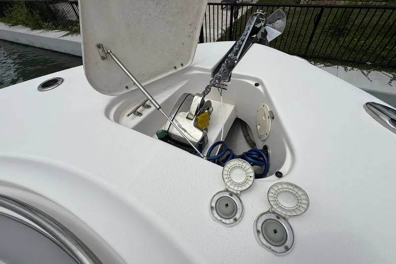 Slide: The Image of 2022 Robalo R302 Center Console anchor compartment with open hatch and visible equipment. - 3