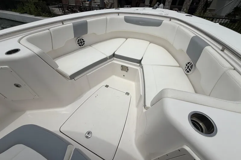 Slide: The Image of 2022 Robalo R302 Center Console boat with spacious seating area and cup holders. - 4