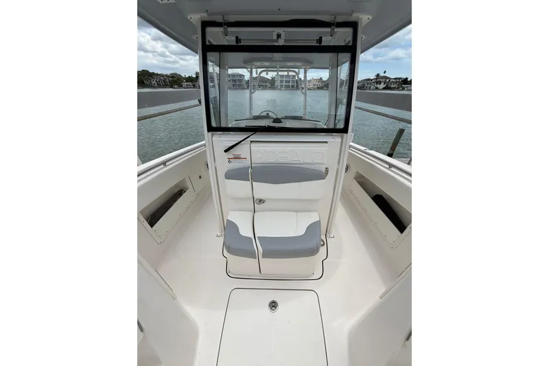 Slide: The Image of 2022 Robalo R302 Center Console boat interior with seating and water view. - 5