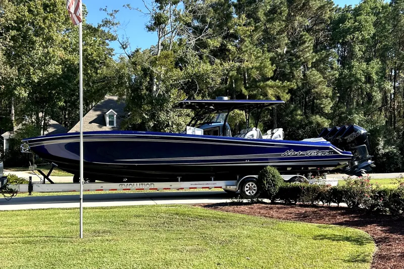 Slide: The Image of 2021 Nortech 390 Sport boat on trailer, parked outdoors with trees in background. - 5