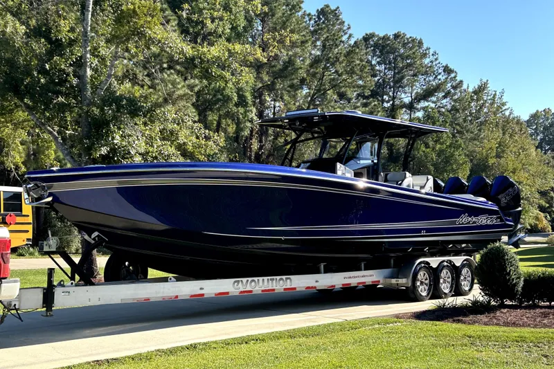 Slide: The Image of 2021 Nortech 390 Sport boat on trailer, parked outdoors with trees in background. - 8