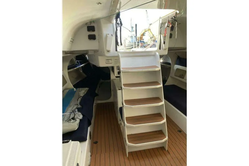 Slide: The Image of Interior of 1995 Nelson Marek 46 sailboat with wooden steps and cozy seating. - 10