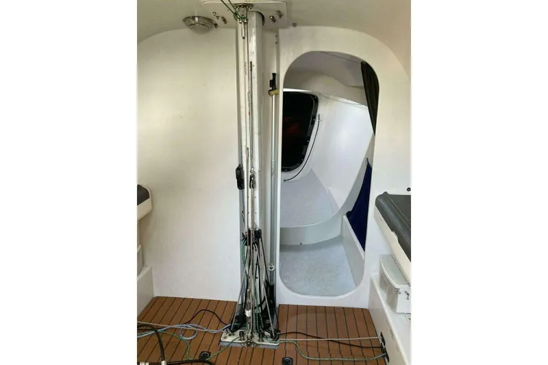 Slide: The Image of Interior of a 1995 Nelson Marek 46 sailboat, featuring mast and cabin entrance. - 15