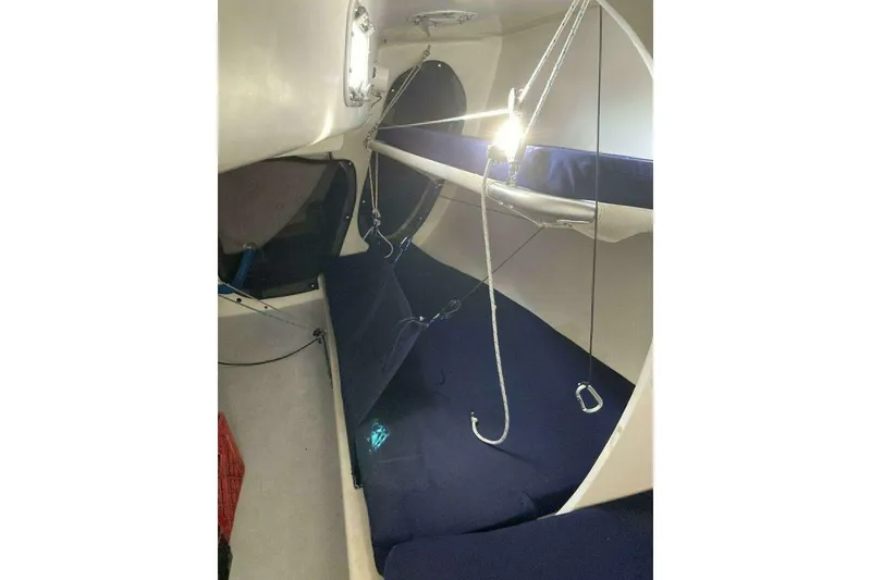 Slide: The Image of Interior of a 1995 Nelson Marek 46 sailboat with blue cushioned seating and ropes. - 16