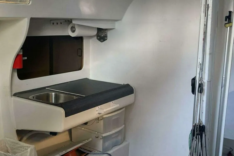 Slide: The Image of Compact galley kitchen in a 1995 Nelson Marek 46 sailboat, featuring a sink and storage. - 18