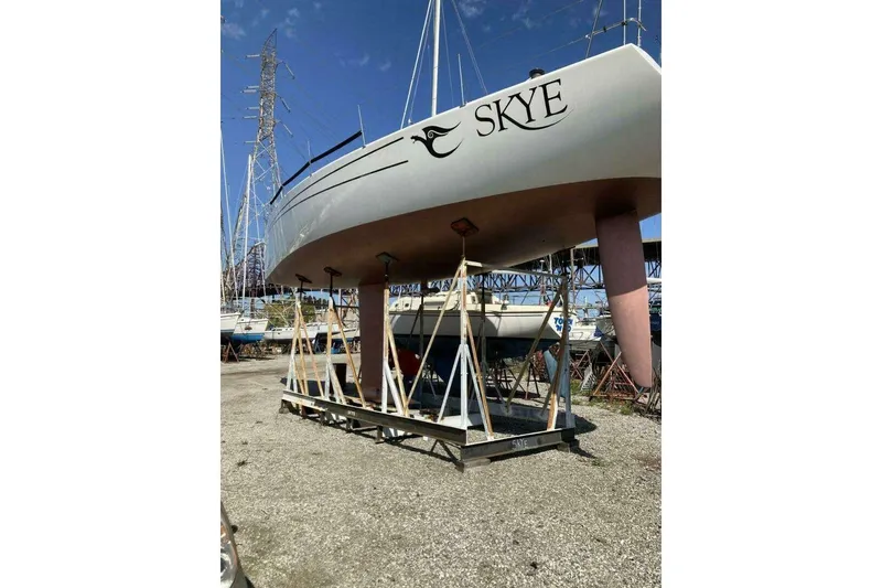 Slide: The Image of Nelson Marek 46 sailboat named "Skye" on stands, 1995 model, in a boatyard. - 7