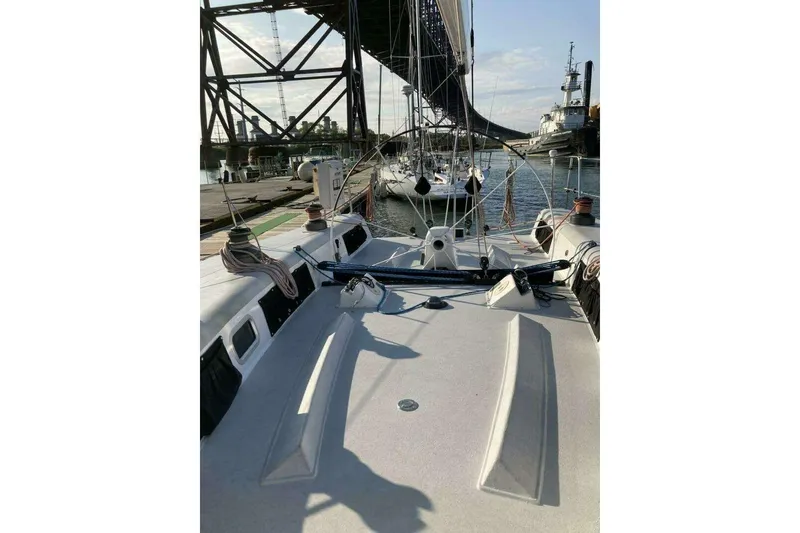 Slide: The Image of Sailboat deck view of 1995 Nelson Marek 46 under a bridge at a marina. - 8