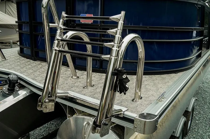Slide: The Image of 2026 Trifecta LE 22RF pontoon boat with stainless steel ladder and blue paneling. - 11