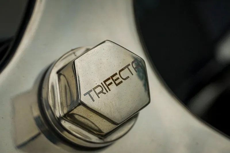 Slide: The Image of Close-up of Trifecta LE 22RF 2026 wheel nut with engraved logo. - 26