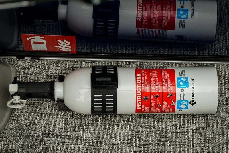 Slide: The Image of Fire extinguisher with instructions inside a 2026 Trifecta LE 22RF boat. - 36