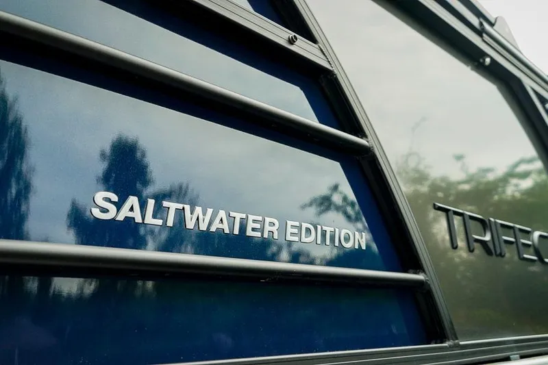 Slide: The Image of 2026 Trifecta LE 22RF Saltwater Edition boat with reflective blue surface. - 4