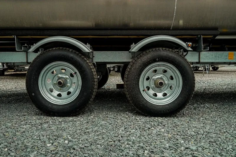 Slide: The Image of Dual wheels of a 2026 Trifecta LE 22RF trailer on gravel surface. - 46