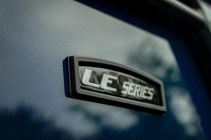 Slide: The Image of Close-up of 2026 Trifecta LE 22RF emblem on a sleek blue surface. - 5