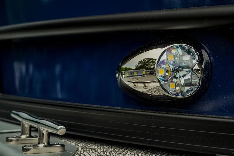 Slide: The Image of Close-up of 2026 Trifecta LE 22RF boat's LED light and cleat on blue exterior. - 9
