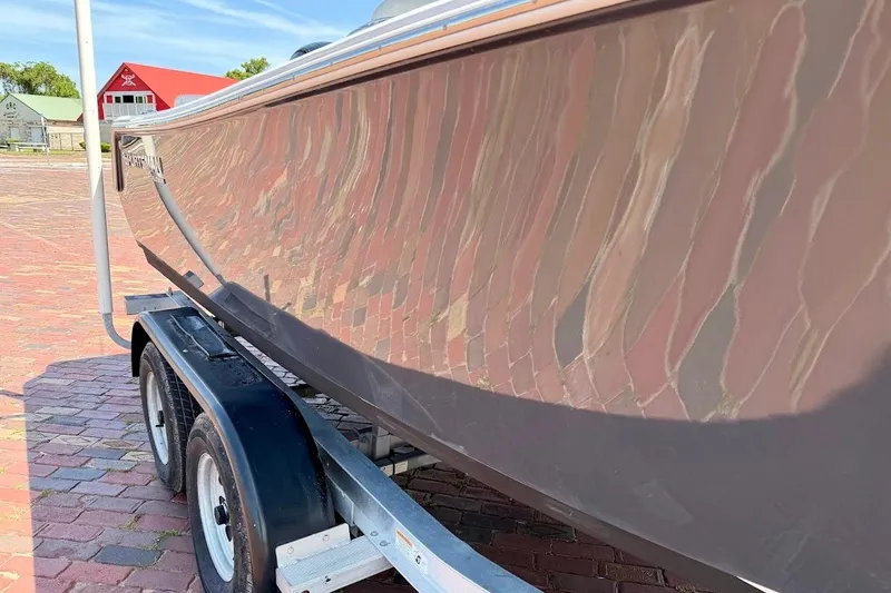 Slide: The Image of 2020 Sportsman Heritage 211 Center Console boat on trailer, brick pavement background. - 10