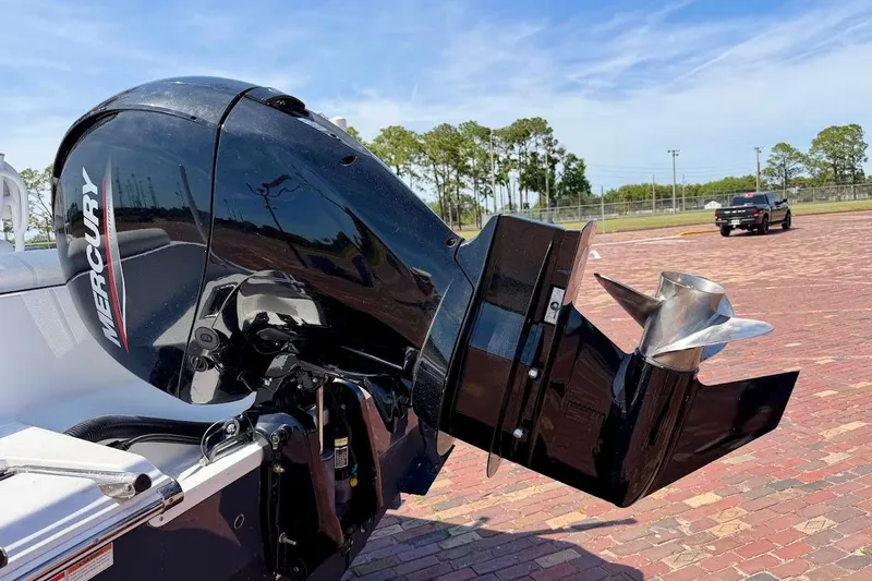 Slide: The Image of Outboard motor on 2020 Sportsman Heritage 211 Center Console boat, parked on brick pavement. - 12