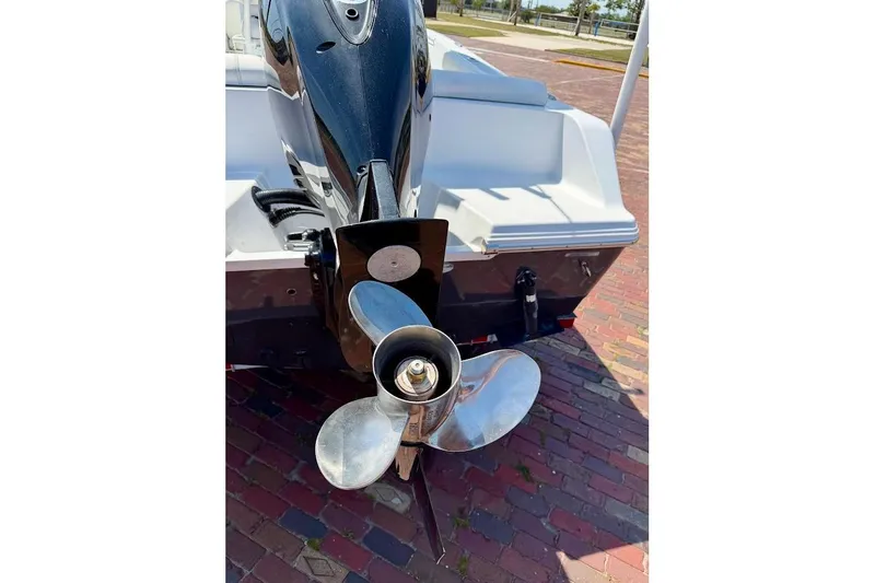Slide: The Image of 2020 Sportsman Heritage 211 Center Console boat with outboard motor and propeller. - 13