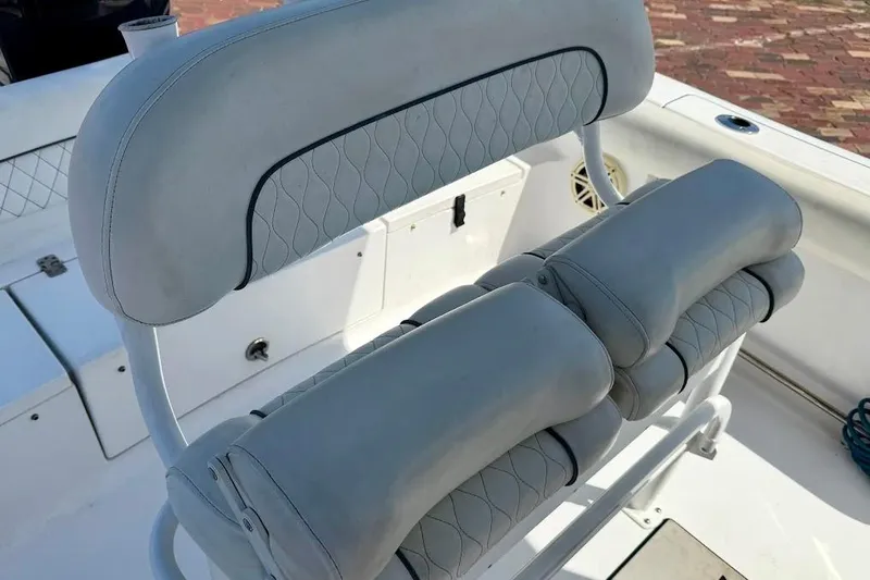 Slide: The Image of 2020 Sportsman Heritage 211 Center Console boat seat with cushioned backrest and armrests. - 16