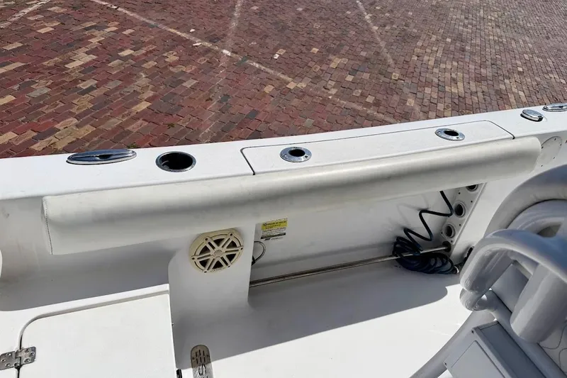 Slide: The Image of 2020 Sportsman Heritage 211 Center Console boat interior with rod holders and speaker. - 18