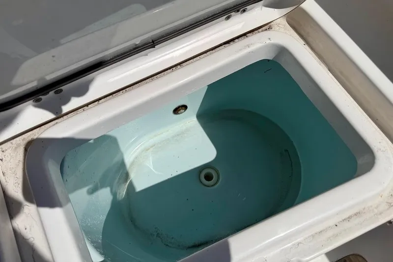 Slide: The Image of Livewell compartment on a 2020 Sportsman Heritage 211 Center Console boat. - 19