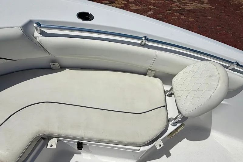 Slide: The Image of 2020 Sportsman Heritage 211 Center Console boat seating area with white cushioned seats. - 30