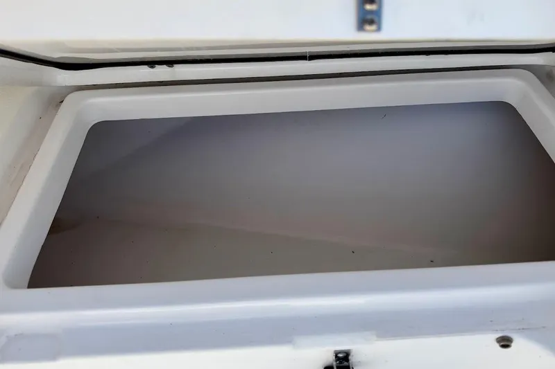 Slide: The Image of Open storage compartment on a 2020 Sportsman Heritage 211 Center Console boat. - 33