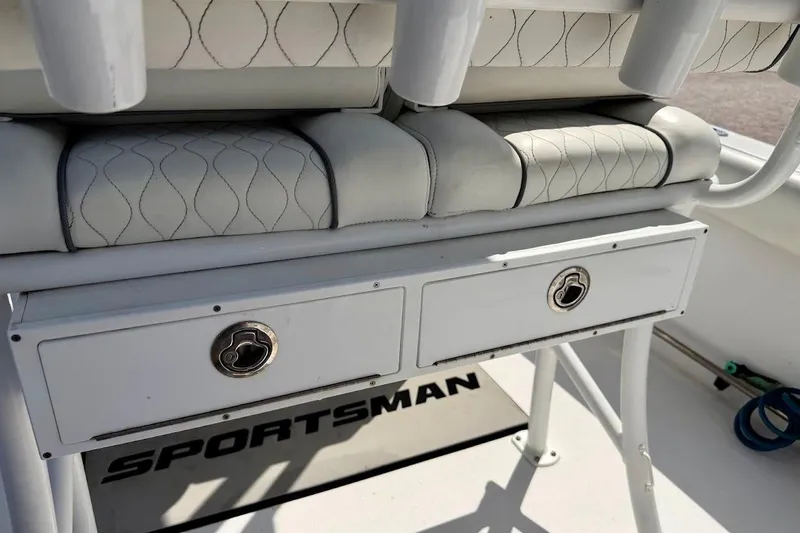 Slide: The Image of 2020 Sportsman Heritage 211 Center Console boat interior with storage drawers and cushioned seating. - 37
