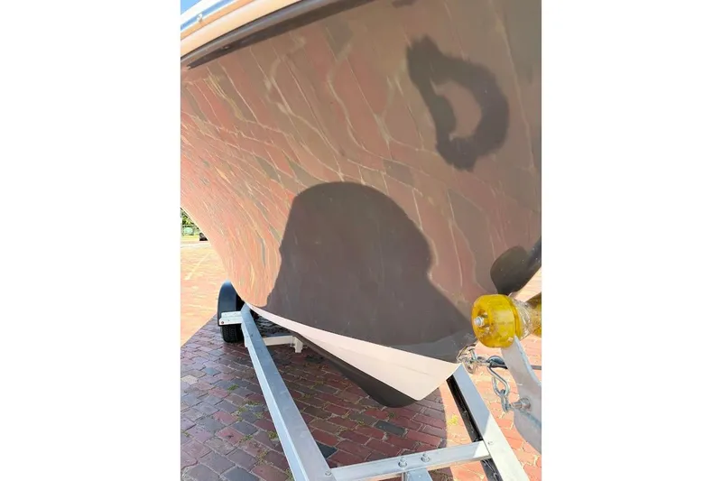 Slide: The Image of 2020 Sportsman Heritage 211 Center Console boat on trailer, brick pavement background. - 9