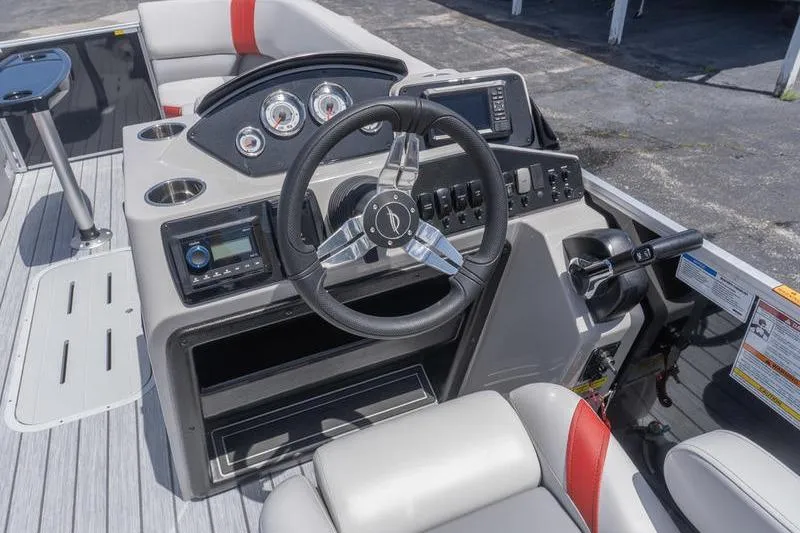 Slide: The Image of Helm of 2026 SunCatcher Select 322SL boat with modern controls and seating. - 11