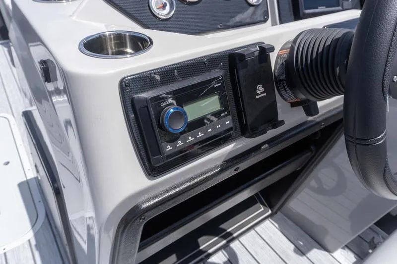 Slide: The Image of Dashboard of 2026 SunCatcher Select 322SL boat with stereo system and steering wheel. - 12