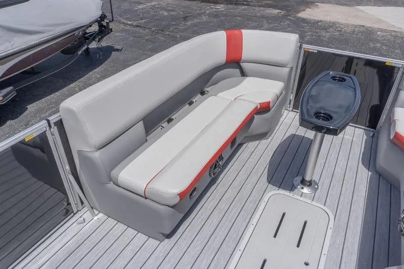 Slide: The Image of 2026 SunCatcher Select 322SL pontoon boat interior with gray and red seating, and table. - 16
