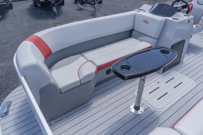 Slide: The Image of 2026 SunCatcher Select 322SL boat interior with gray seating and a sleek table. - 18