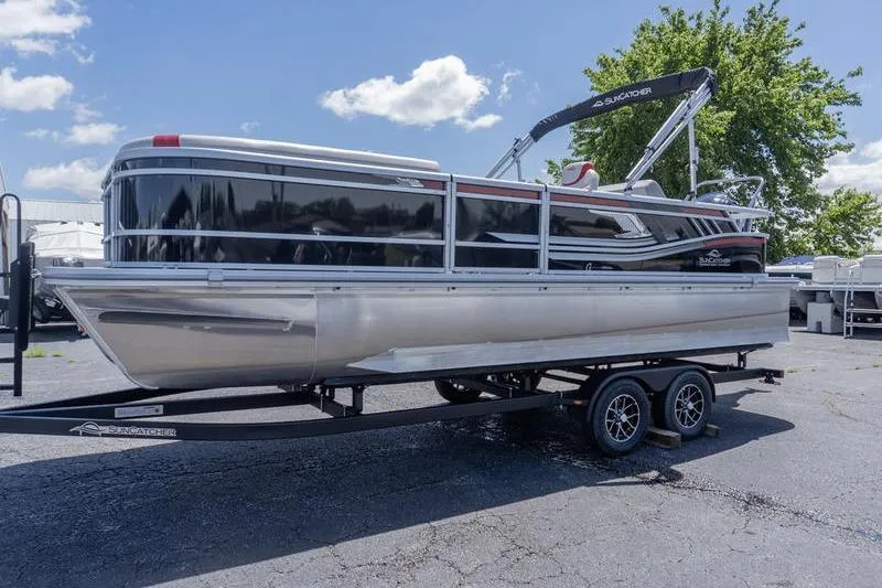 Slide: The Image of 2026 SunCatcher Select 322SL pontoon boat on trailer, parked outdoors under a clear sky. - 4