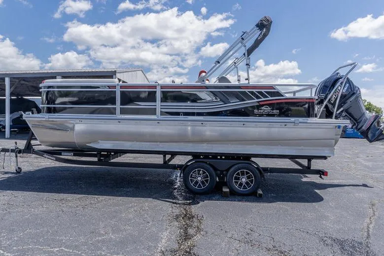 Slide: The Image of 2026 SunCatcher Select 322SL pontoon boat on trailer under a blue sky. - 5