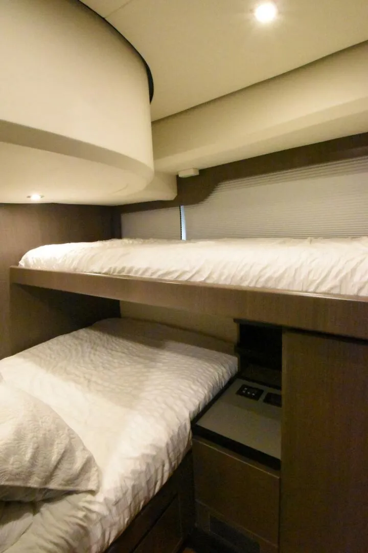Slide: The Image of 2024 OKEAN 52 yacht interior with cozy bunk beds and modern design. - 13