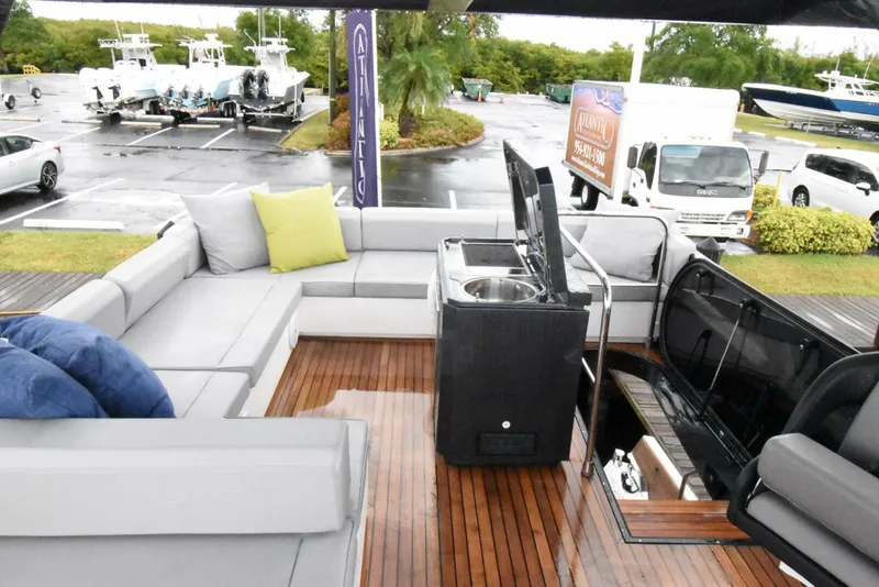 Slide: The Image of Luxurious 2024 OKEAN 52 yacht deck with modern seating and entertainment area. - 15