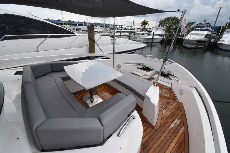 Slide: The Image of Luxurious 2024 OKEAN 52 yacht with sleek seating and modern design at a marina. - 17