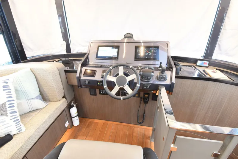 Slide: The Image of 2024 OKEAN 52 yacht helm with modern navigation equipment and comfortable seating. - 20