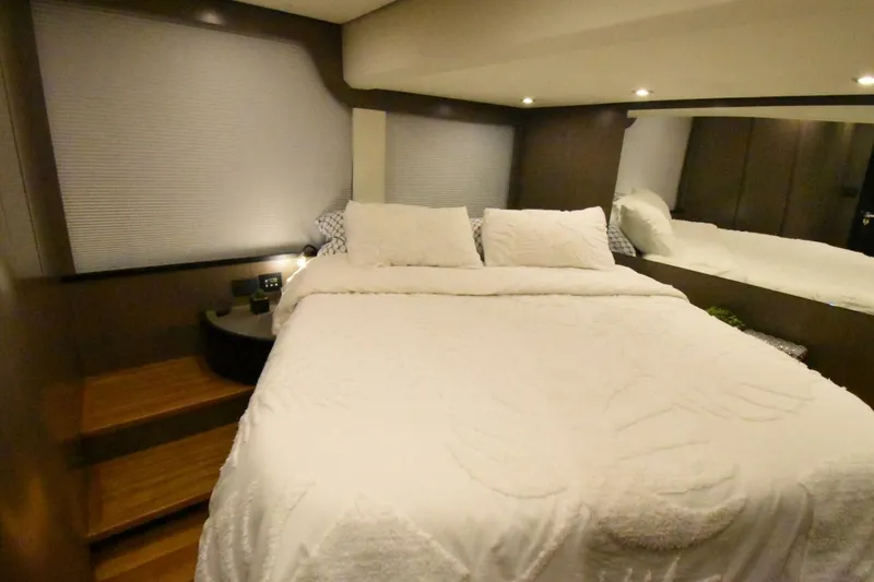Slide: The Image of Luxurious bedroom interior of 2024 OKEAN 52 yacht with cozy bedding and ambient lighting. - 21