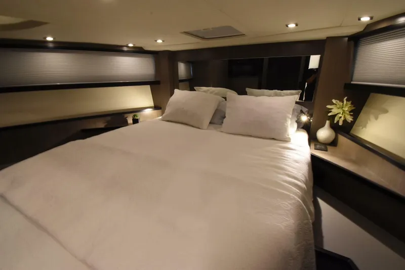 Slide: The Image of Luxurious bedroom interior of 2024 OKEAN 52 yacht with cozy bedding and ambient lighting. - 25