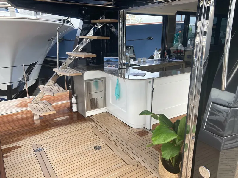 Slide: The Image of Luxurious 2024 OKEAN 52 yacht interior with wooden deck and modern staircase. - 29