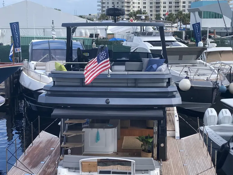 Slide: The Image of 2024 OKEAN 52 yacht docked, featuring modern design and American flag. - 33